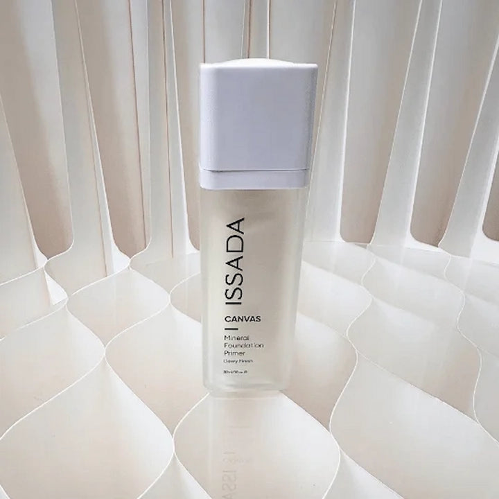 ISSADA Canvas Mineral Foundation Primer bottle on a textured white background