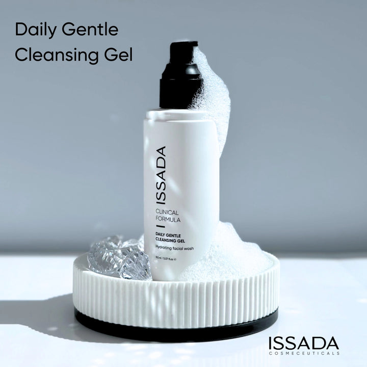 Issada Daily Gentle Cleansing Gel bottle on a white platform with foam, showcasing the hydrating facial wash packaging in a clean minimal design.