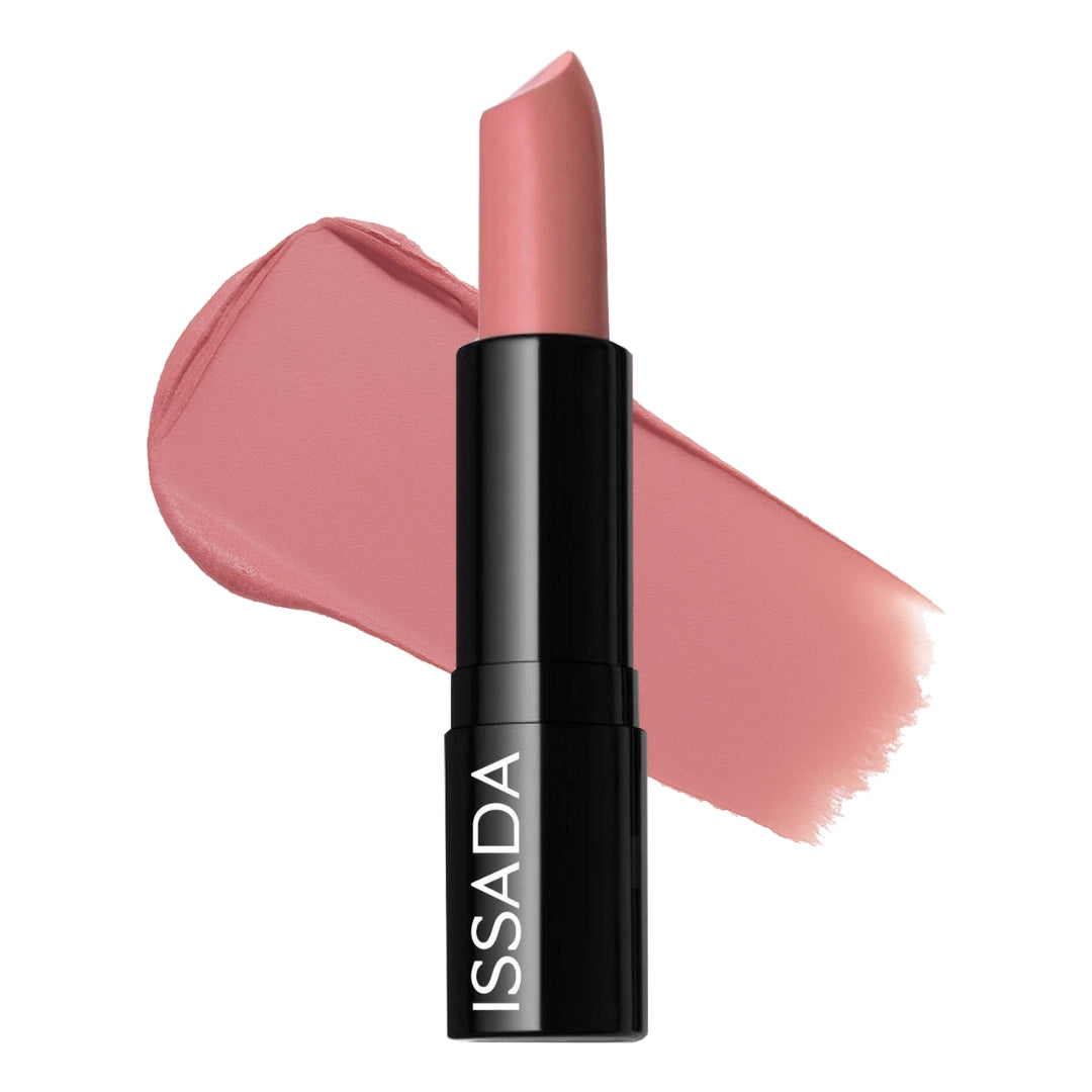 Issada Mineral Cream Lipstick in Darling Dahlia shade with a soft pink nude swatch behind the tube, showcasing its creamy texture and satin finish. Issada Mineral Cream Lipstick in Darling Dahlia shade with a soft pink nude swatch behind the tube, showcasing its creamy texture and satin finish.