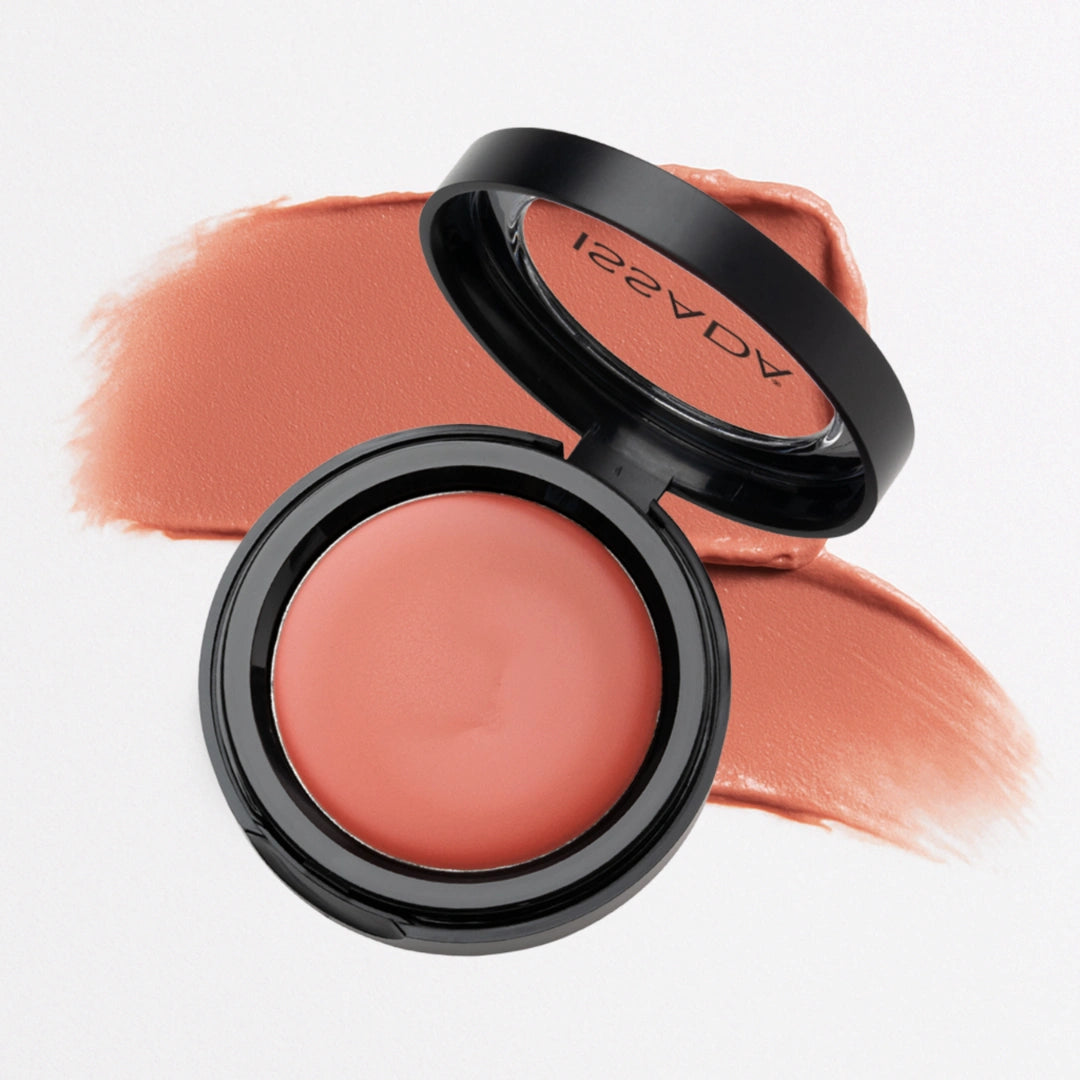 Issada Mineral Lip & Cheek Cream in Mango Frappe, a warm peachy coral shade, shown with a matching color swatch behind the open compact. Issada Mineral Lip & Cheek Cream in Mango Frappe, a warm peachy coral shade, shown with a matching color swatch behind the open compact.