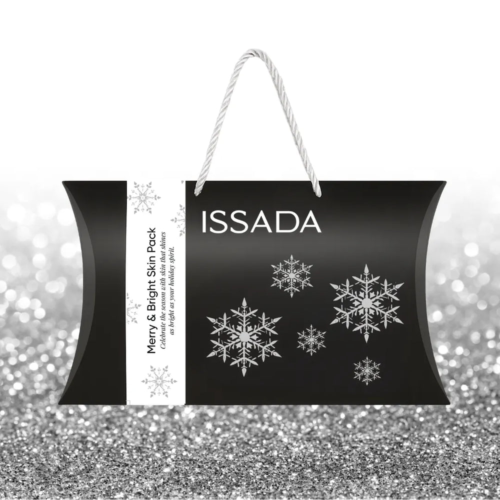 ISSADA skincare product packaging with snowflake designs on a glittery background