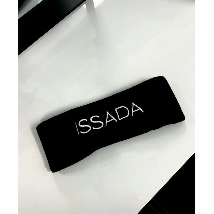 Black Issada cosmetic headband with embroidered logo, ideal for holding hair back during skincare or makeup application.