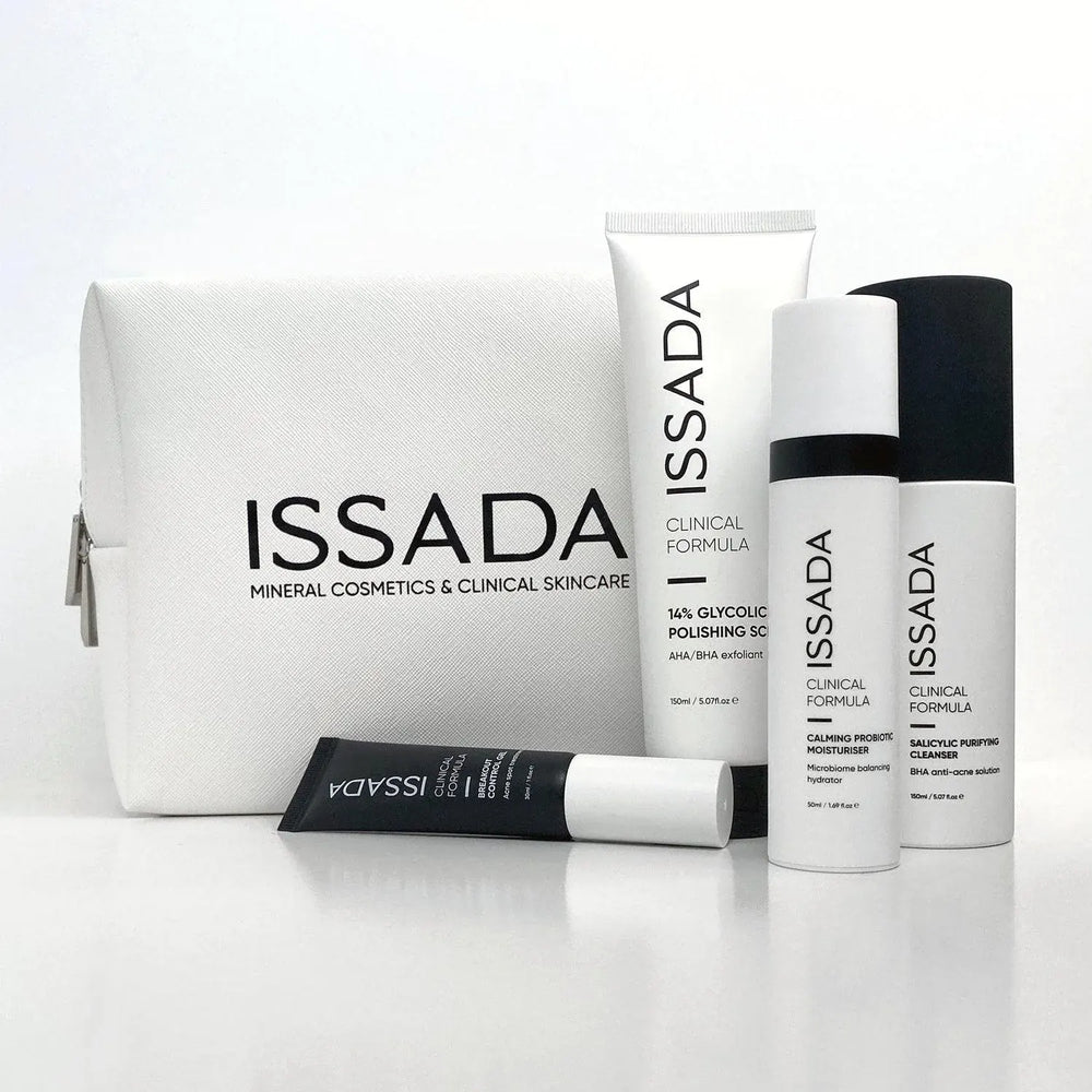 Issada white cosmetic bag with clinical formula skincare products including cleanser, moisturiser, exfoliant, and serum.