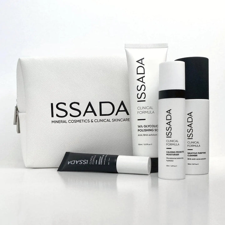 Issada white cosmetic bag with clinical formula skincare products including cleanser, moisturiser, exfoliant, and serum.