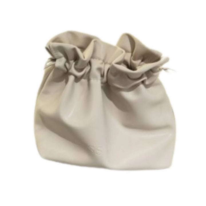 Issada cream drawstring cosmetic pouch for makeup and skincare storage.