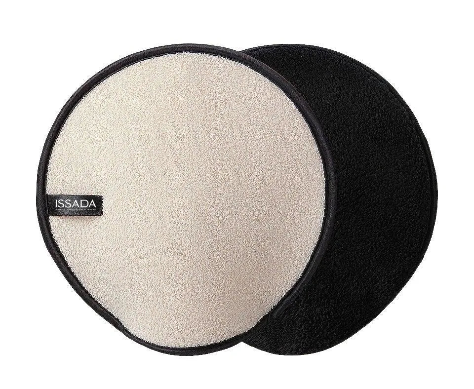 Issada dual-sided exfoliating body mitt in black and beige, reusable skincare glove for smooth, radiant skin.