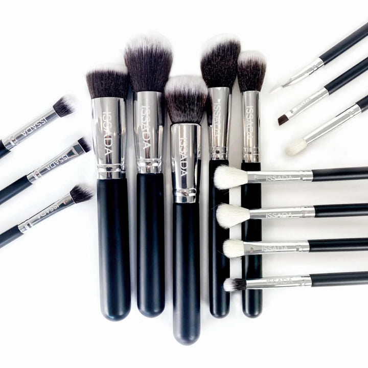 Issada 15-piece vegan makeup brush set flatlay with soft bristles, sleek black handles, and professional quality design for flawless makeup application.