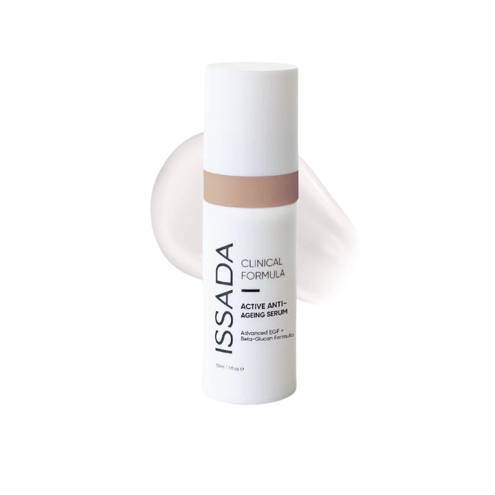 Issada Active Anti-Ageing Serum bottle with beige accent displayed in front of a light cream product swatch on a white background.