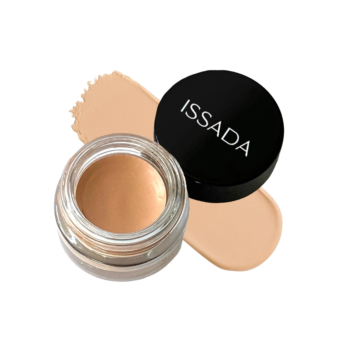 ISSADA Antioxidant Shadow Magnet eye primer in glass jar with flesh toned cream swatch designed to enhance eyeshadow pigment and prevent creasing