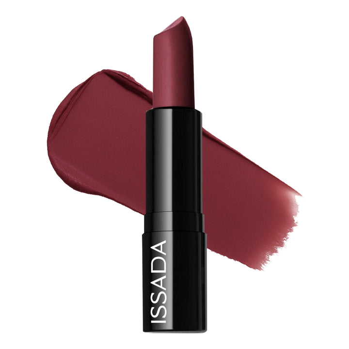 Issada Mineral Cream Lipstick in Belle Berry shade with a rich berry-red swatch behind the tube, highlighting its creamy, hydrating texture and satin finish.