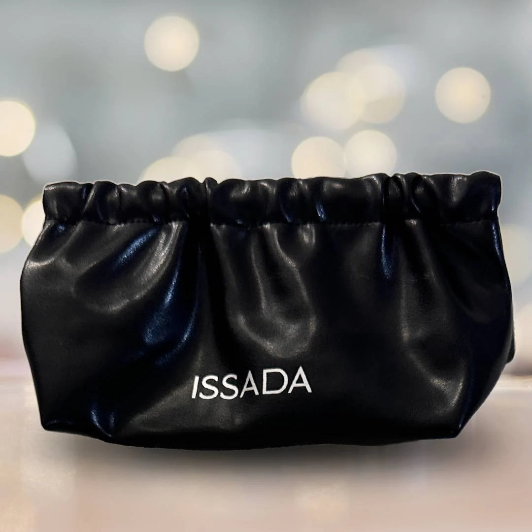 Elegant Issada black clutch makeup bag with soft gathered design, ideal for storing brushes and cosmetics.