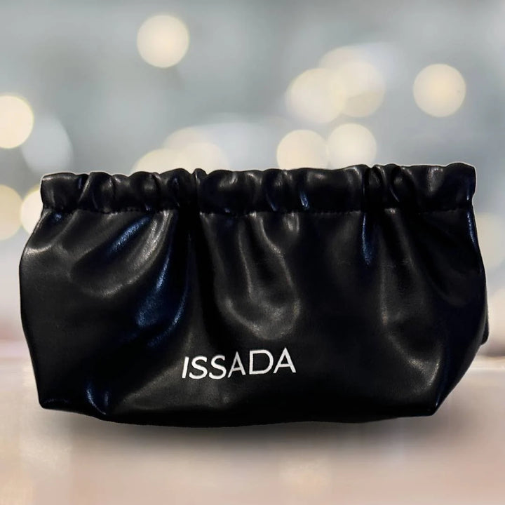 Elegant Issada black clutch makeup bag with soft gathered design, ideal for storing brushes and cosmetics.