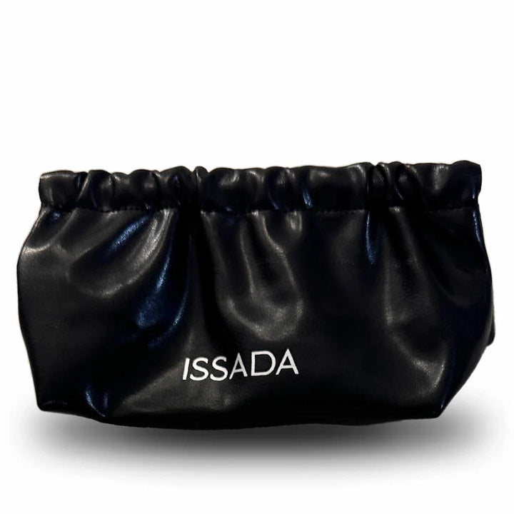 Sleek black Issada drawstring makeup pouch with white logo, designed for storing cosmetics and skincare essentials.