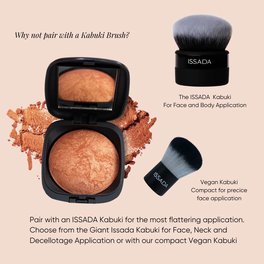 ISSADA Mineral Beach Babe bronzer, vegan kabuki brush, and a brush on a beige background.