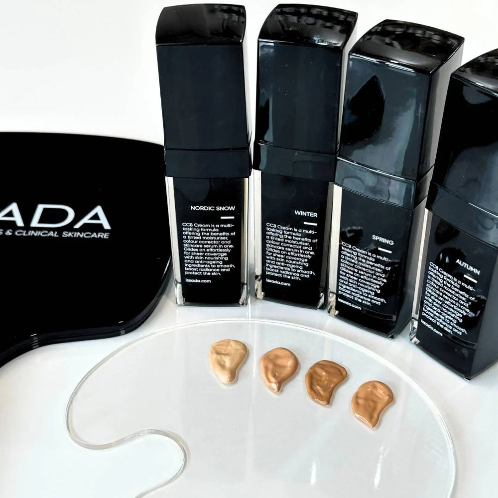 Four bottles of Issada CC8 Cream in shades Nordic Snow, Winter, Spring, and Autumn with swatches displayed on a palette on a white background