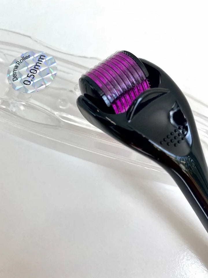 Issada 0.50mm derma roller with black handle and purple microneedle head in clear protective case.