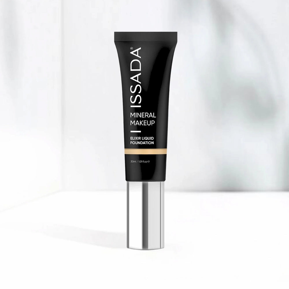 ISSADA Elixir Liquid Foundation tube with silver pump, lightweight mineral makeup for flawless skin on a white background