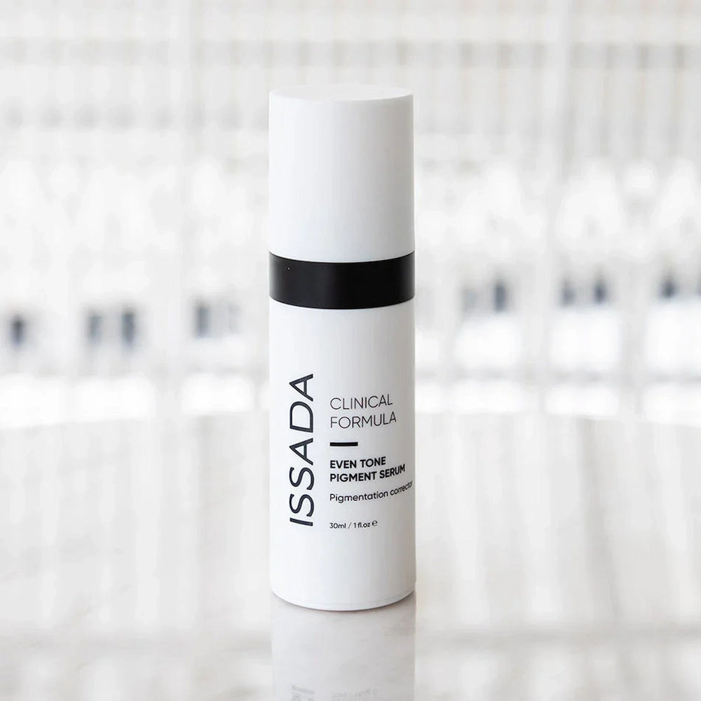 ISSADA Even Tone Pigment Serum Corrector on a reflective surface, formulated to correct pigmentation and promote an even complexion.
