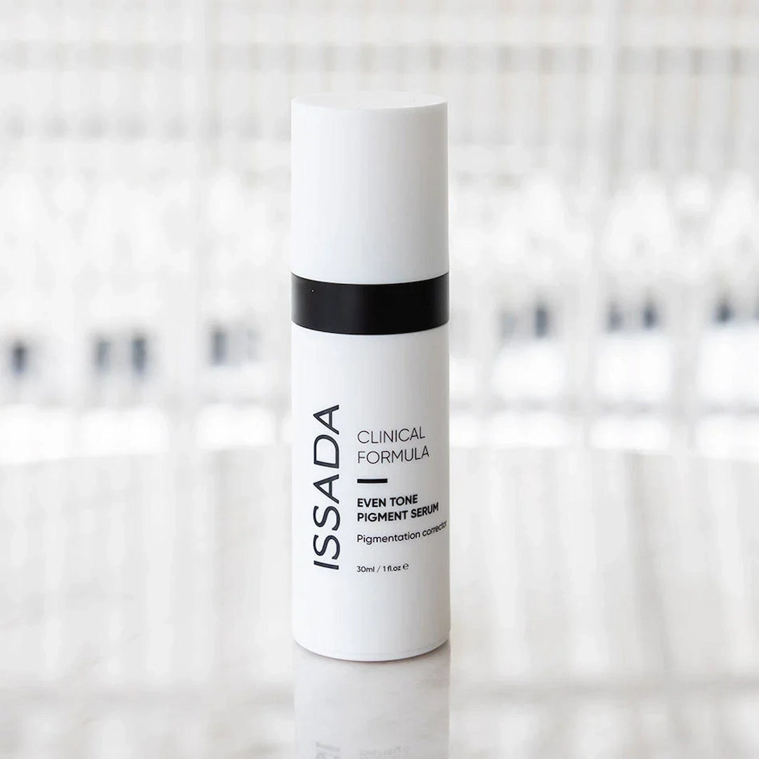 ISSADA Even Tone Pigment Serum Corrector on a reflective surface, formulated to correct pigmentation and promote an even complexion.