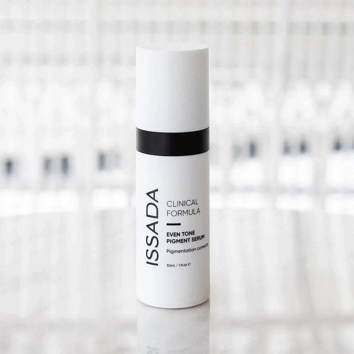 ISSADA Even Tone Pigment Serum Corrector on a reflective surface, formulated to correct pigmentation and promote an even complexion.