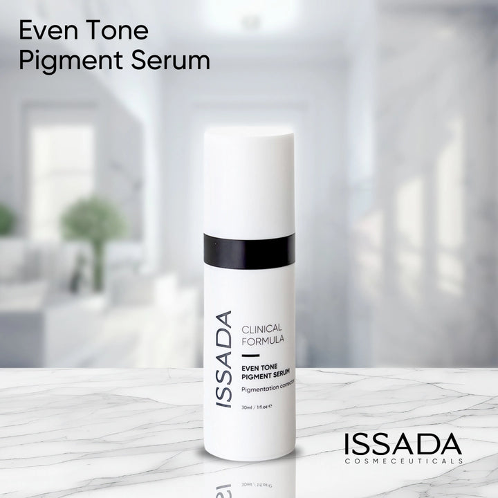 Issada Clinical Formula Even Tone Pigment Serum bottle placed on a marble surface with a bright, modern background, showcasing a clean and professional aesthetic.