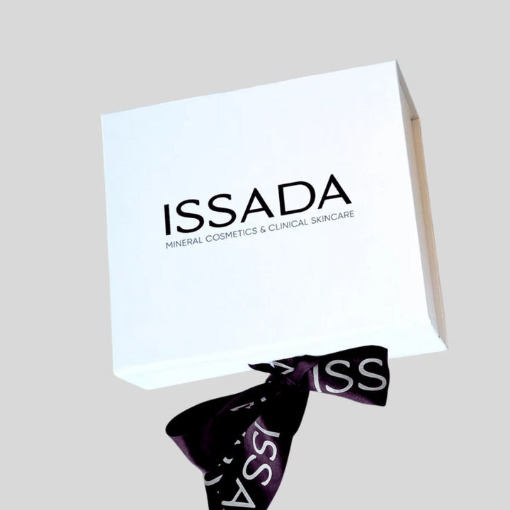 Elegant Issada white gift box tied with a black branded ribbon, perfect for presenting luxury skincare and makeup.