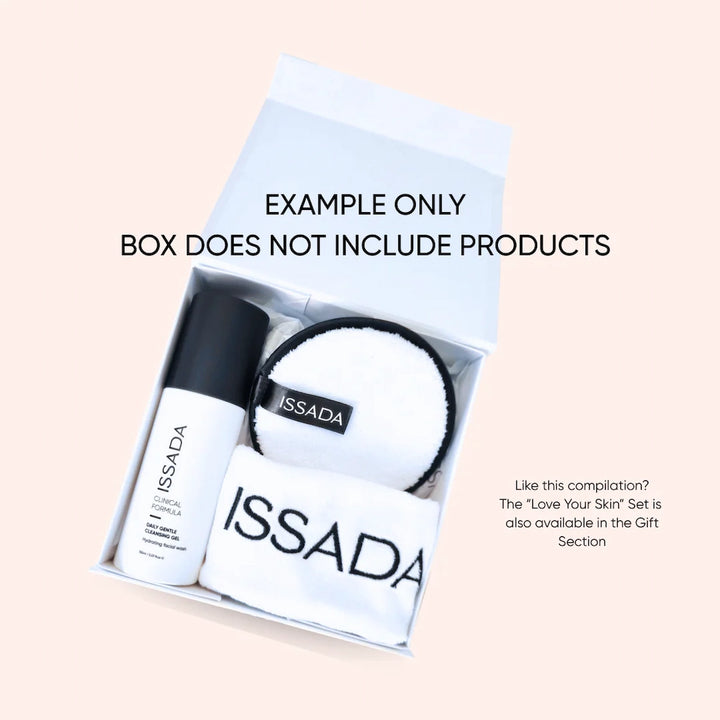 Open Issada gift box shown with sample skincare and accessories inside. Example display only, box sold separately without products.
