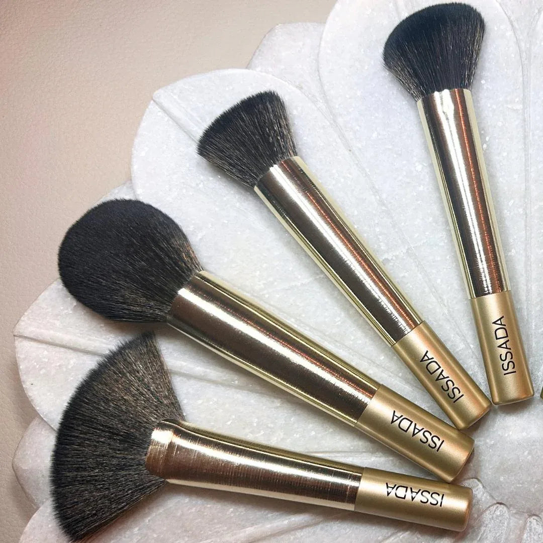 Issada Gold Professional Makeup Brushes featuring powder, contour, blush, and fan brushes with luxe gold handles and soft bristles.