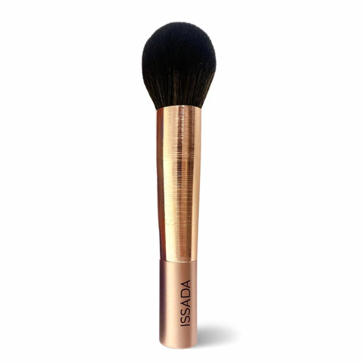 Issada Gold Professional Makeup Brush with sleek golden handle and soft rounded bristles for flawless powder or blush application.