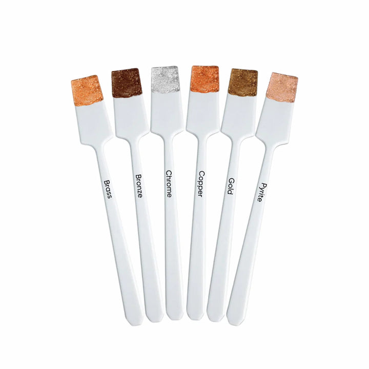 Swatches of ISSADA Liquid Metal Eyeshadow in six shades: Brass, Bronze, Chrome, Copper, Gold, and Pyrite on applicators