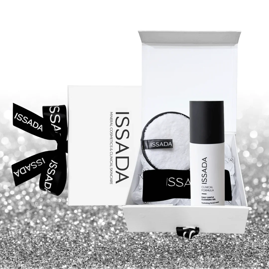 Issada Love Your Skin gift box open, showing Daily Gentle Cleansing Gel, reusable cleansing pad, and black makeup headband with branded gift packaging.