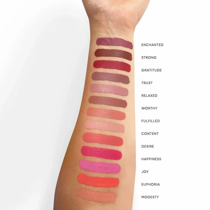 ISSADA Mineral Lip Crayons swatches on a person's arm with descriptive shades.