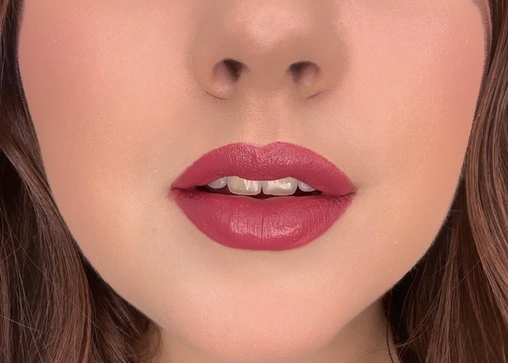 Close-up of a woman's lips with ISSADA Mineral Lip Crayons in Enchanted shade, a rich deep plum rose with a creamy, soft-matte finish.