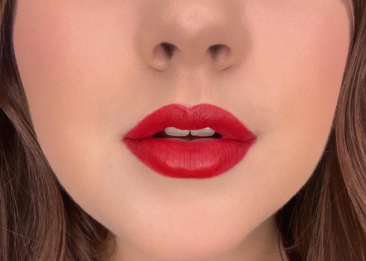 Close-up of a woman's lips wearing Issada Mineral Lip Crayon in Gratitude, a bold classic red lip shade with a creamy, soft-matte finish.