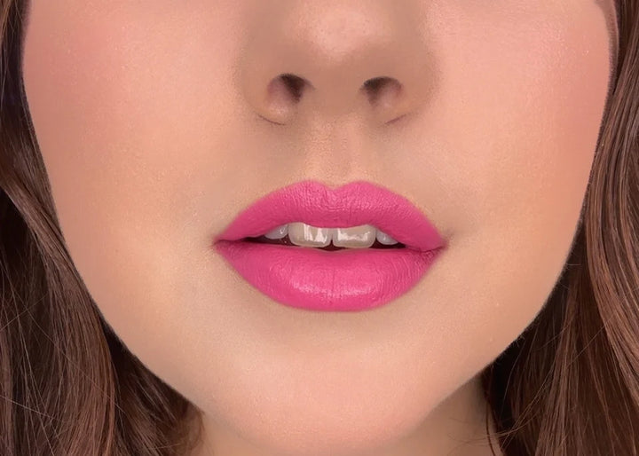 Close-up of model wearing Issada Mineral Lip Crayons in Joy shade, a vibrant playful pink with a creamy, soft-matte finish.