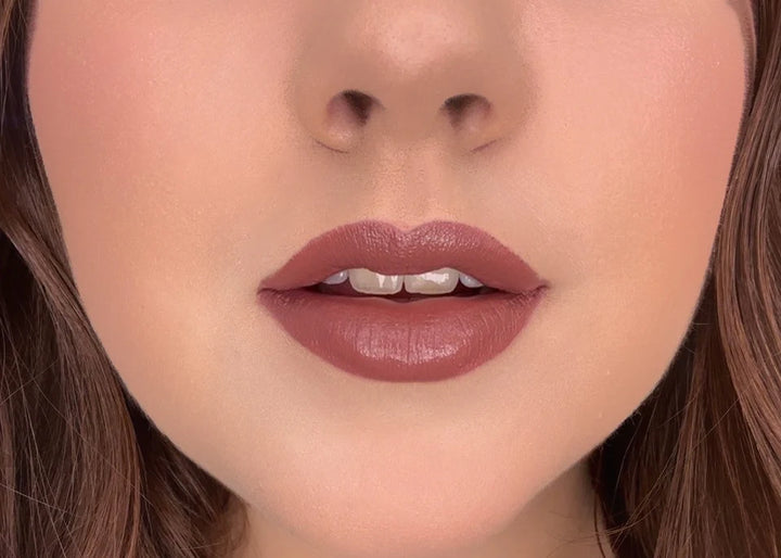 Close-up of a person's lips with ISSADA Mineral Lip Crayons in Trust shade, a creamy mauve-nude with a soft matte finish.