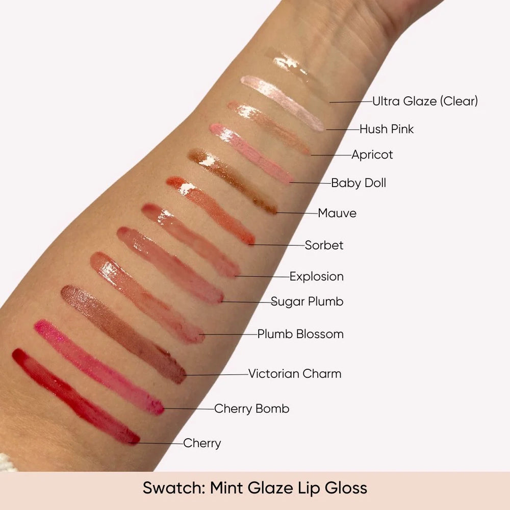 Arm swatch of ISSADA Mineral Mint Glaze Lip Gloss showing 12 shades on a white background