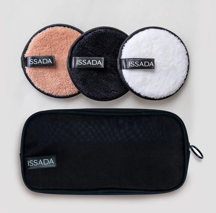 ISSADA reusable cleansing pads in beige, black, and white with a black travel bag for removing makeup, oil, and dirt.