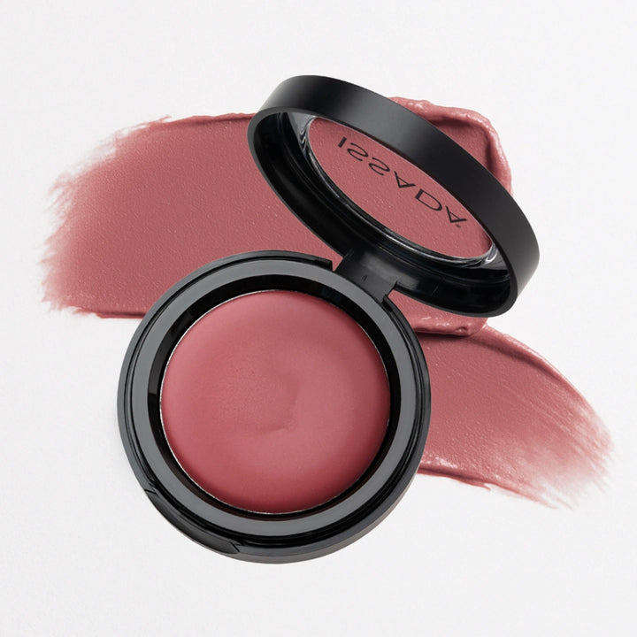 Issada Mineral Lip & Cheek Cream in Pomegranate Punch, a rich berry-rose shade, shown open with a smooth color swatch behind the compact.