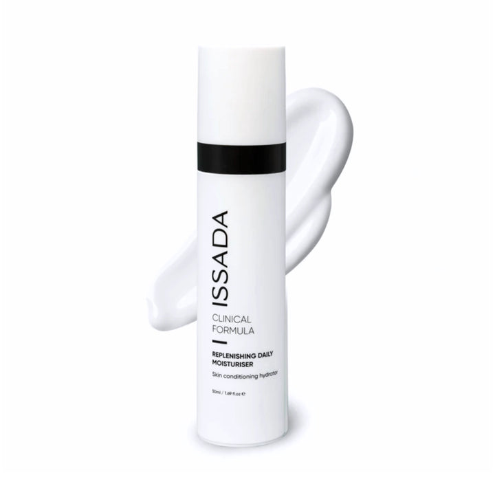 Issada Clinical Formula Replenishing Daily Moisturiser bottle displayed with a smooth white swatch behind it, representing the product’s creamy, hydrating texture.