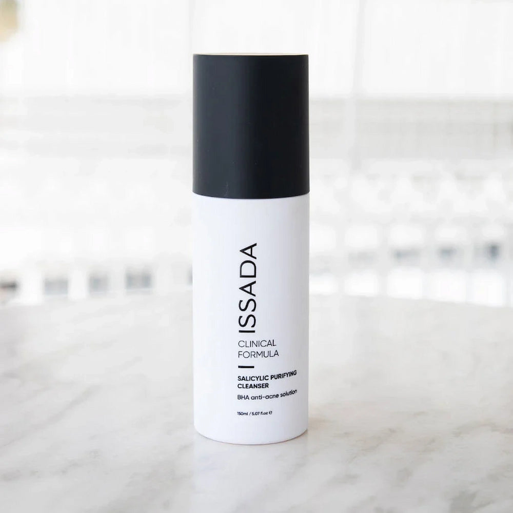ISSADA Salicylic Purifying Cleanser with BHA anti-acne solution on a blurry background
