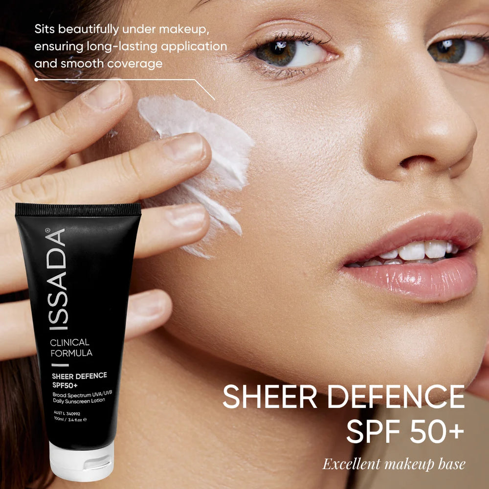 Model applying Issada Sheer Defence SPF50+ sunscreen on face, showing its smooth texture and suitability as a makeup base.