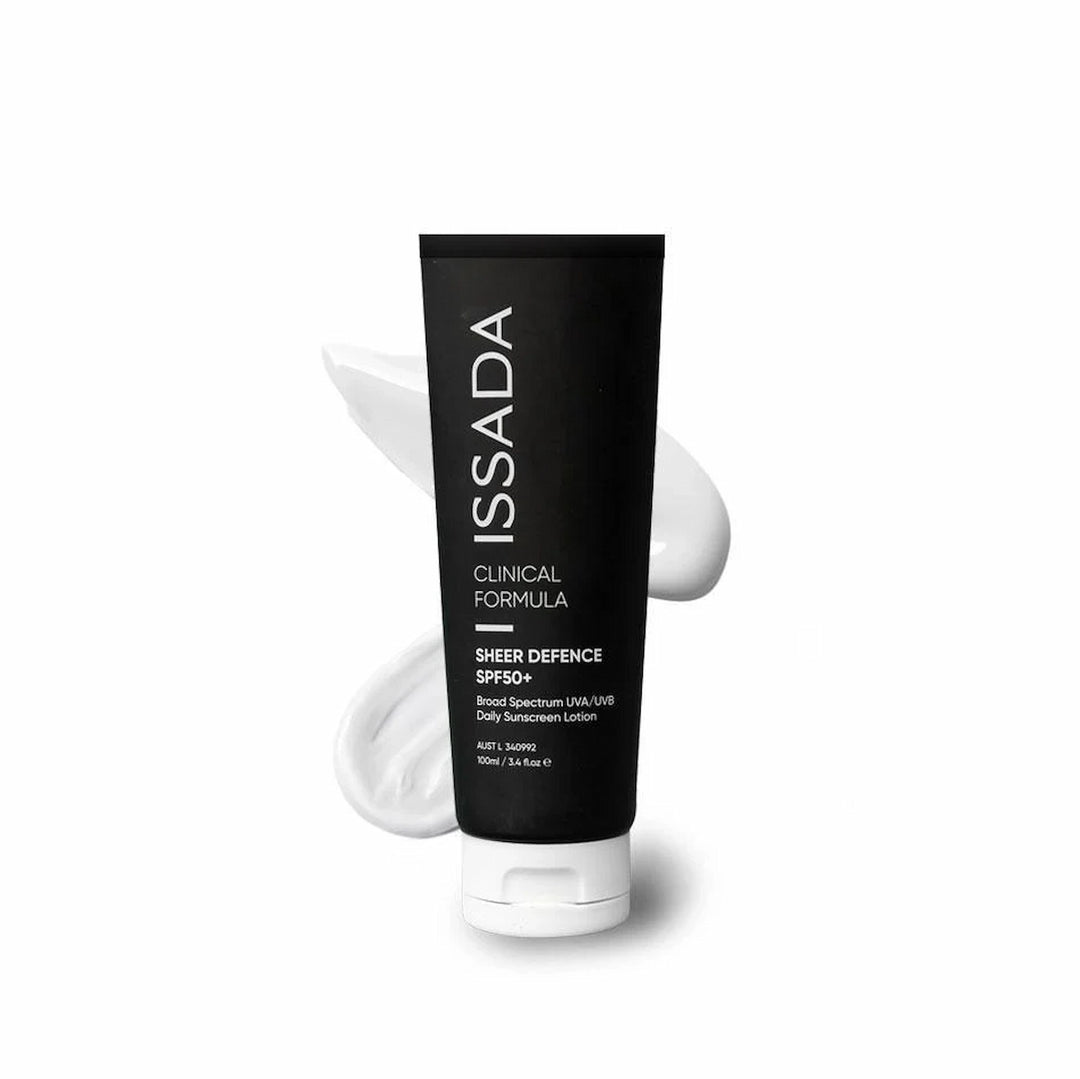 ISSADA Sheer Defence SPF50+ daily sunscreen lotion in a black tube with white cream background.