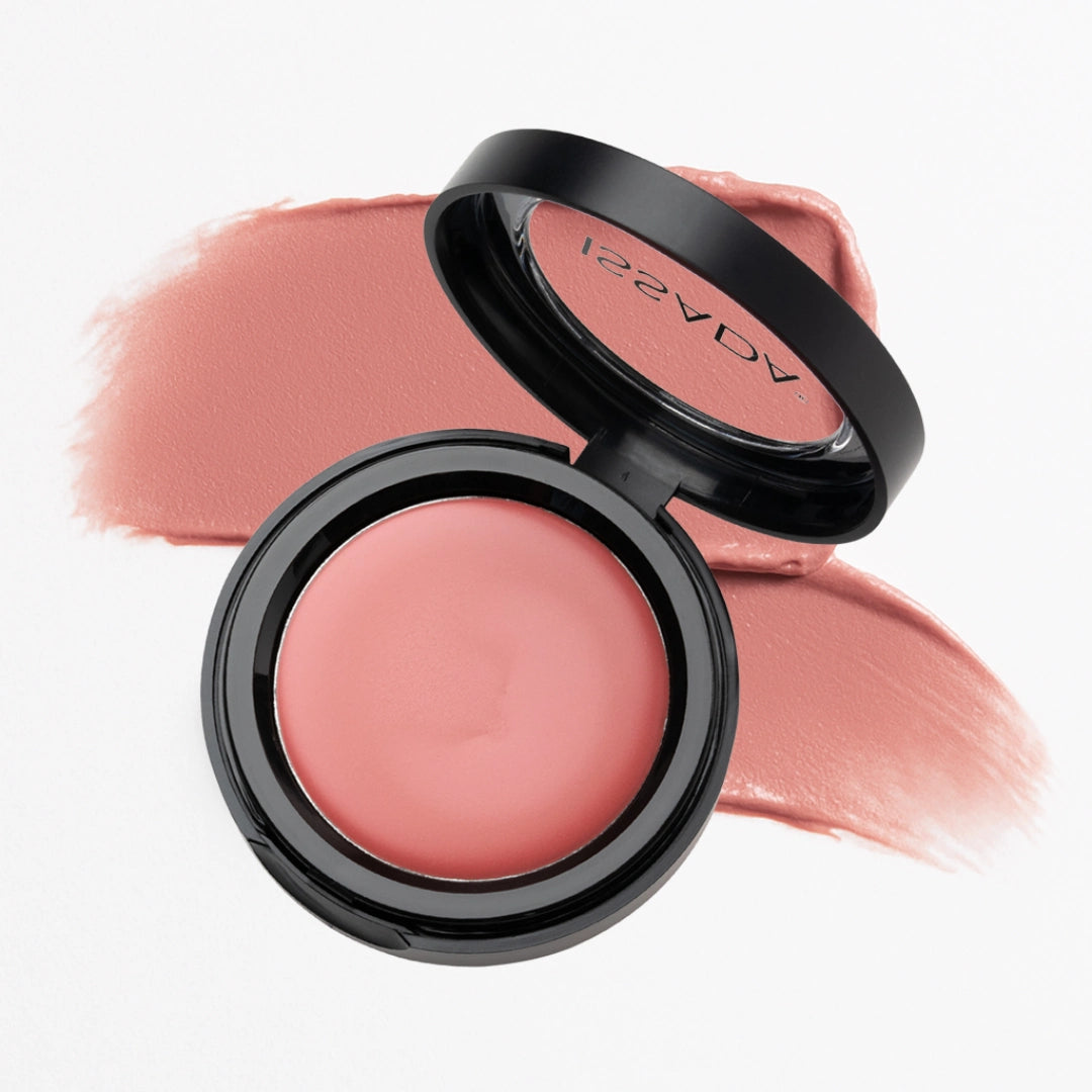 Issada cream blush in Strawberry Milkshake shade with a soft pink swatch behind the open compact, showing its smooth, creamy texture and natural radiant finish.