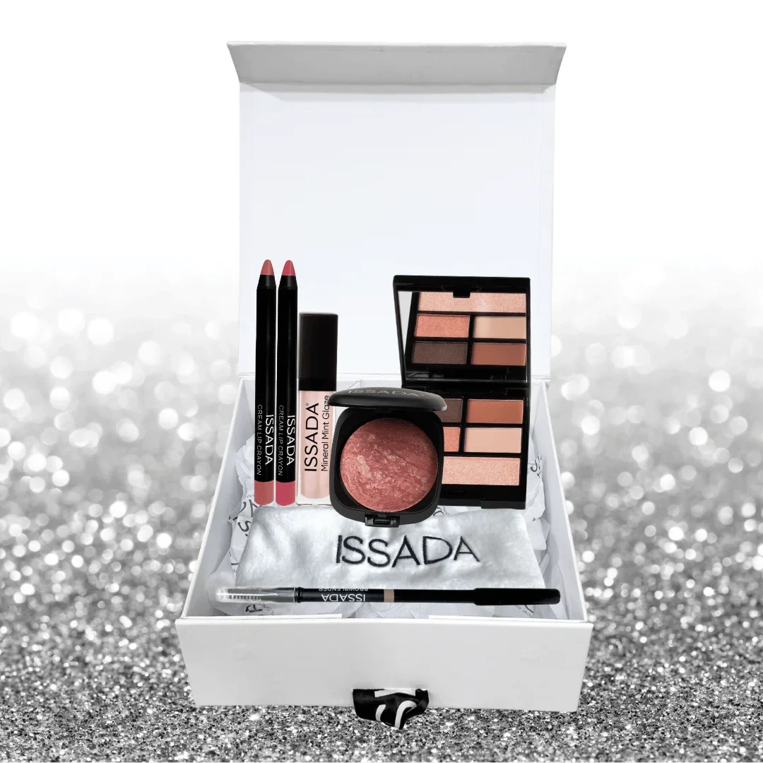 Issada The Party Edit gift box featuring lip crayons, mineral gloss, baked blush, eyeshadow palette, and eyeliner displayed on a silver glitter background.