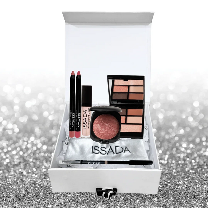 Issada The Party Edit gift box featuring lip crayons, mineral gloss, baked blush, eyeshadow palette, and eyeliner displayed on a silver glitter background.