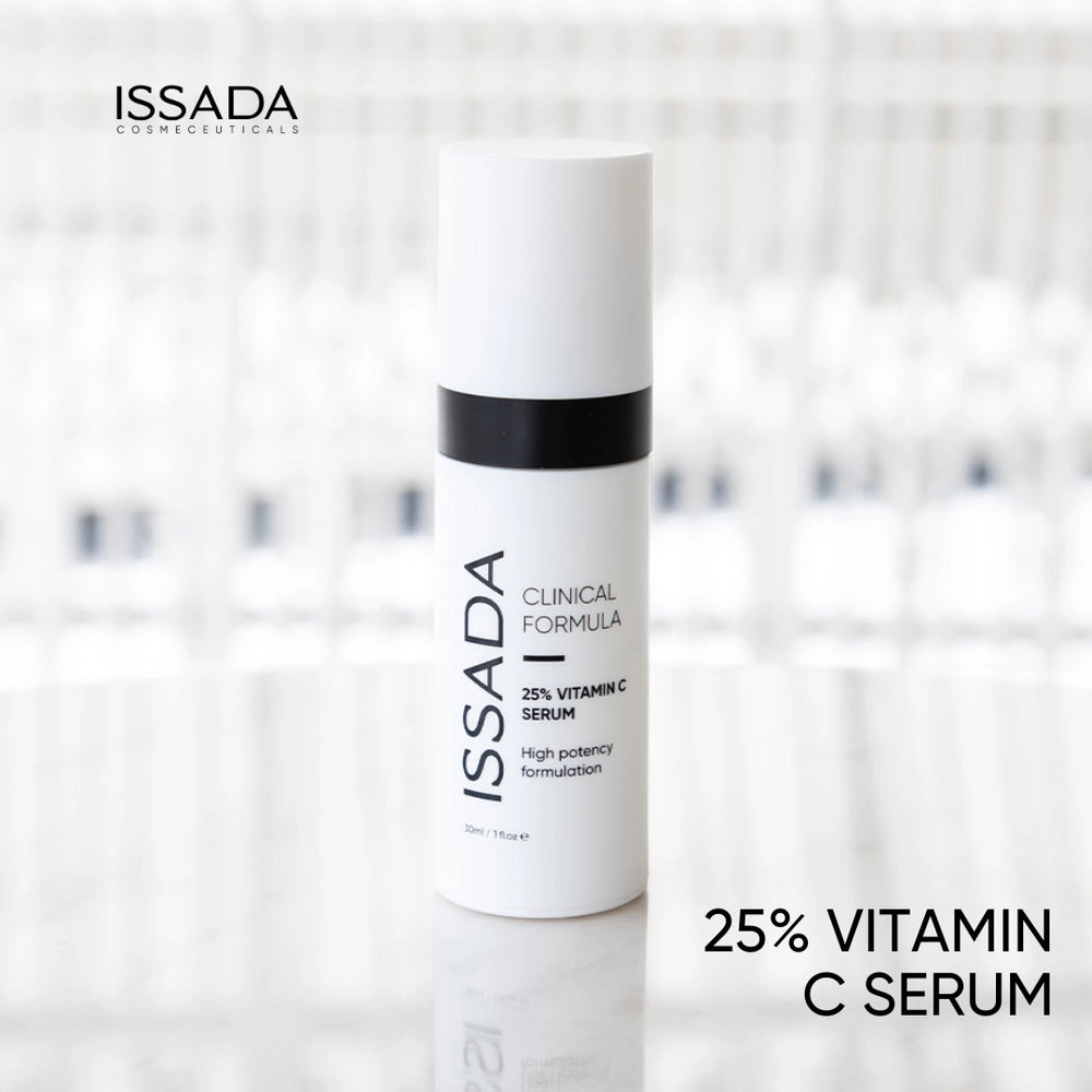 Issada 25% Vitamin C Serum bottle standing on a glossy surface with a softly blurred background, showcasing the product’s sleek clinical design.