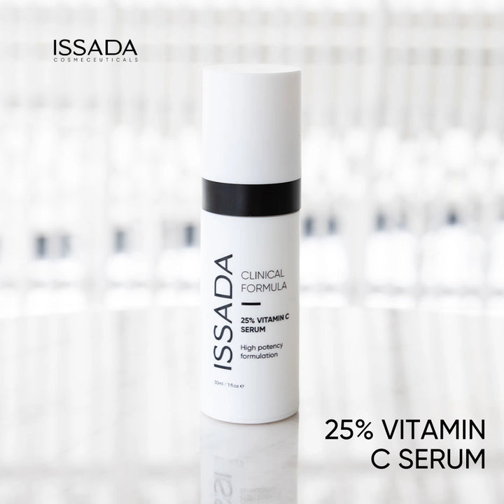 Issada 25% Vitamin C Serum bottle standing on a glossy surface with a softly blurred background, showcasing the product’s sleek clinical design.