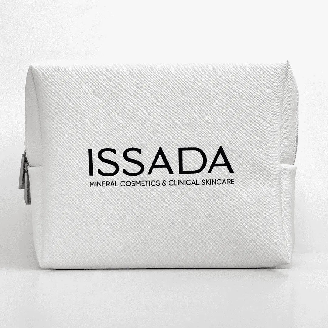 White ISSADA cosmetic bag with black logo, ideal for storing skincare and makeup products on a white background