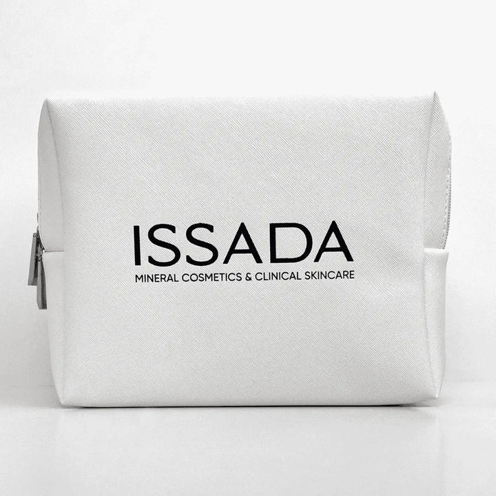 White ISSADA cosmetic bag with black logo, ideal for storing skincare and makeup products on a white background